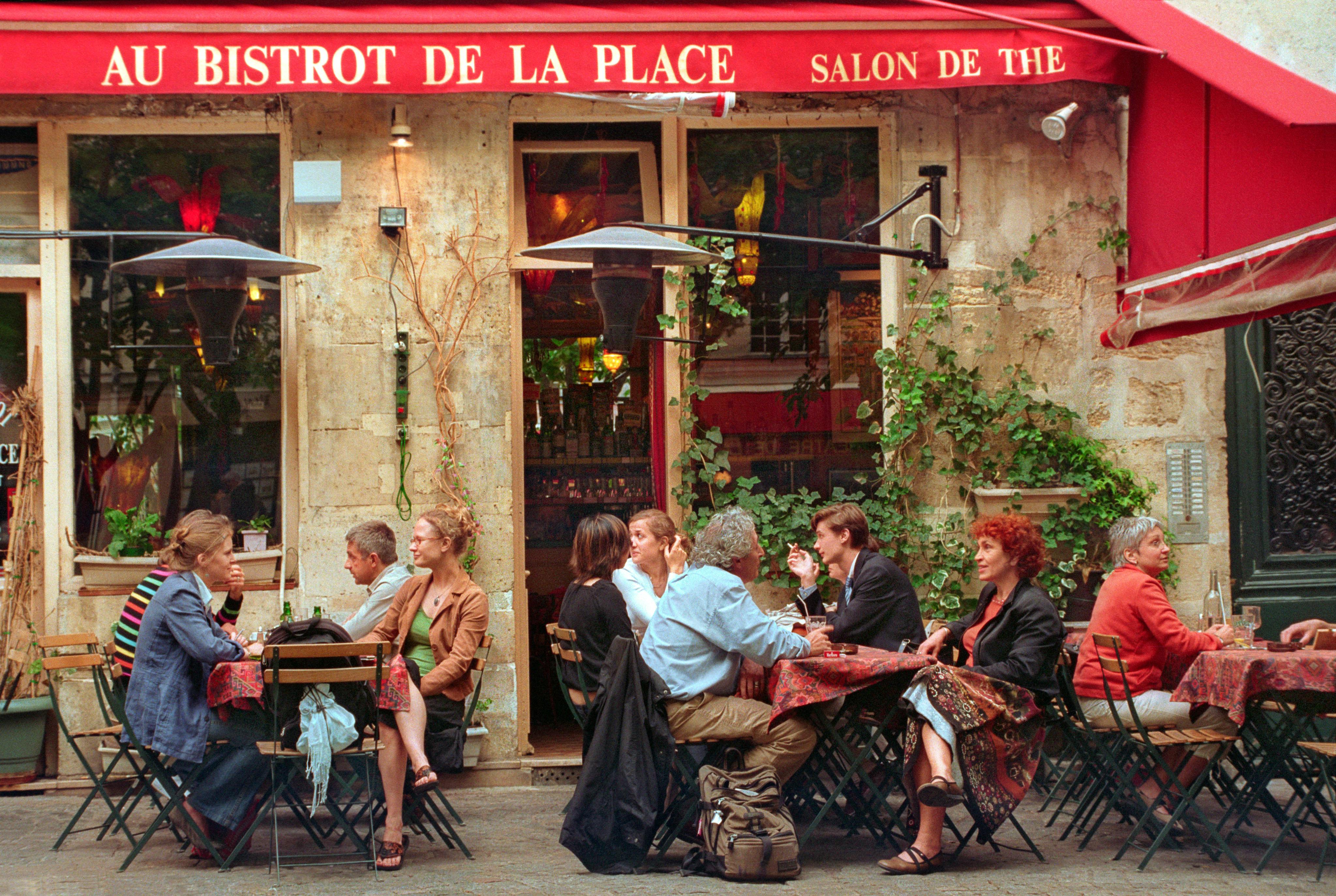 image of people outside a french cafe enjoying a meal